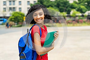 Laughing hispanic female college student with backpack