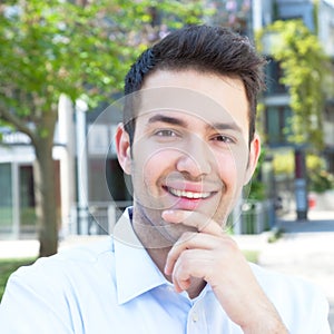 Laughing hispanic guy in a blue shirt