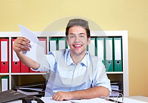 Laughing hispanic guy at office with letter