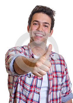 Laughing hispanic guy showing thumb up