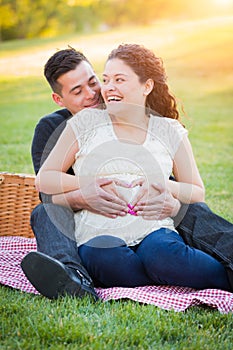 Laughing Hispanic Pregnant Young Couple Portrait Outdoors