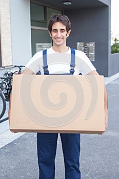 Laughing hispanic worker with box
