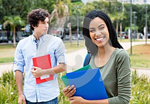 Laughing indian female student with caucasian male student