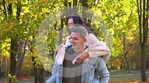 Laughing joyful family. Happy couple having fun in the autumn park