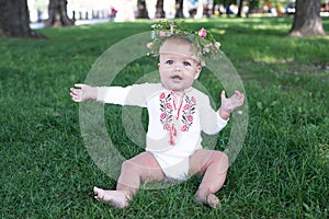 Laughing kid girl 1 year old having fun outdoors