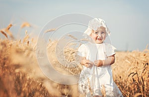 Laughing kid in sunny wheat field