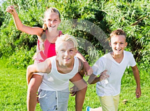 Laughing kids running on grass