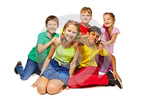 Laughing kids sitting on the floor together