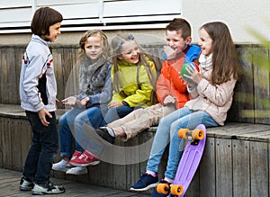 Laughing kids with small ball playing in street