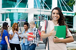 Laughing latin american female student passed exam