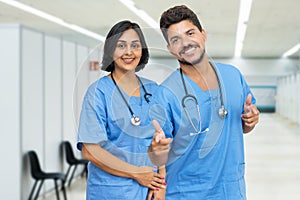 Laughing latin american male and female nurses at vaccination station