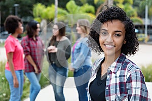 Laughing latin american woman with group of girlfriends