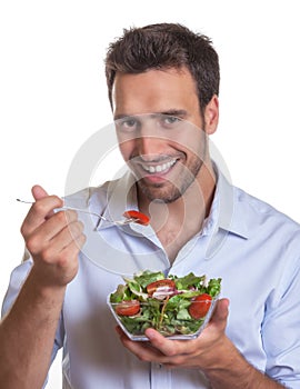 Laughing latin man with fresh salad