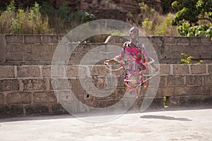 Laughing Little African Girl Tangled In Her Skipping Rope While Playing Outdoor