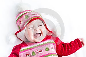 Laughing little baby in Christmas knitted hat