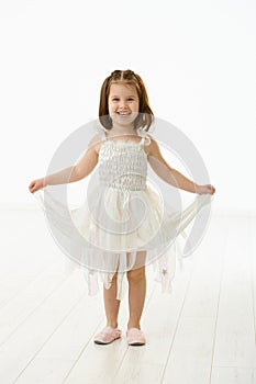 Laughing little girl in ballet costume