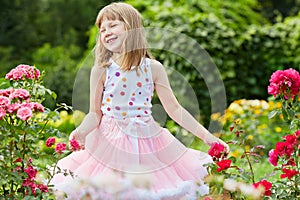 Laughing little girl dressed in suit with puffy photo