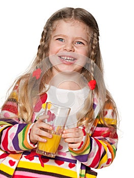Laughing little girl with a glass of orange juice