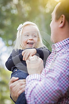 Laughing Little Girl Having Fun With Daddy Outdoors