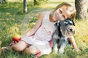 Laughing little girl hugging her dog