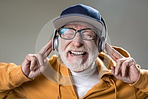 Laughing male person with earphones on head