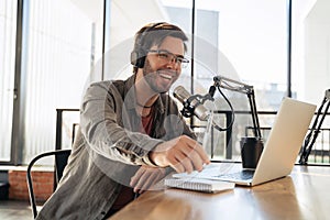 Laughing man host streaming podcast in studio