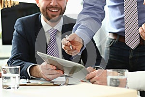 Laughing man in office with tablet