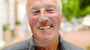 Laughing man showing white teeth or dentures after dental treatment in the city. Closeup headshot and face portrait of a