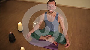 Laughing man sitting in the lotus position