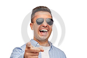 Laughing man in sunglasses pointing finger on you photo