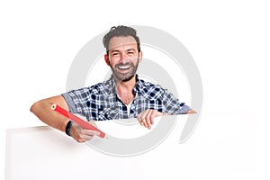 Laughing mature man writing over blank poster