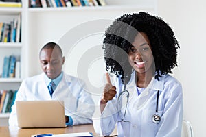 Laughing medical student with general practitioner photo