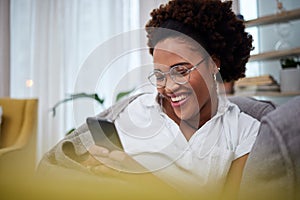 Laughing, meme and woman with phone on a couch using the internet, web and search on social media for joke. Online