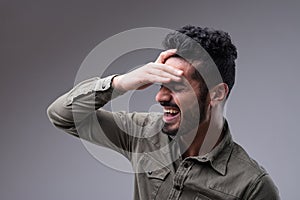 Laughing Middle Eastern man, side-portrait, fit