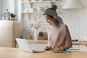 Young woman resting from chores having fun looking on pc