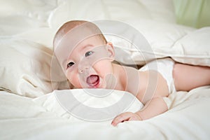 Laughing Mixed Race Baby Boy Having Fun on His Blanket