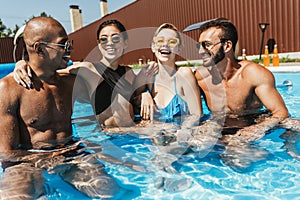 laughing multiethnic couples in sunglasses spending time