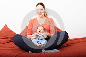 Laughing mum with newborn baby girl