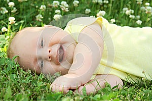 Laughing Newborn Baby Laying in Grass OUtside