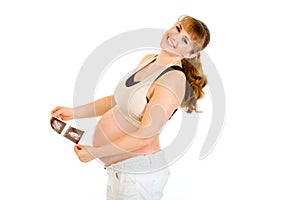 Laughing pregnant woman holding echo in hands