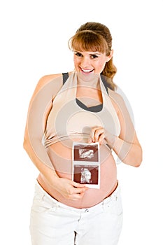 Laughing pregnant woman holding echo in hands