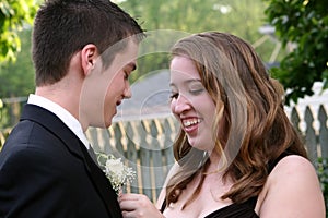 Laughing Prom Girl Fixing Boutonniere