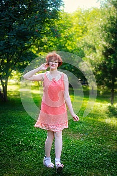 Laughing red haired girl on a sunny day having fun