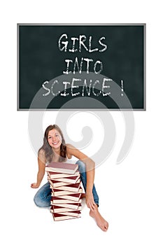 Laughing schoolgirl with a huge pile of books in front of a blackboard