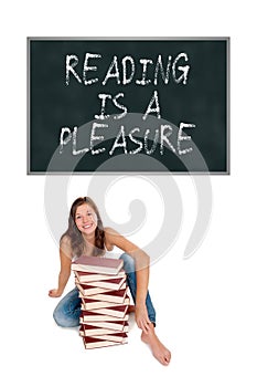 Laughing schoolgirl with a huge pile of books in front of a blackboard