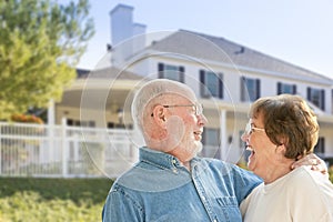 Laughing Senior Couple in Front Yard of House