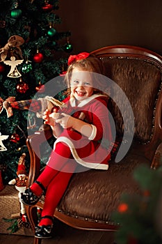 Laughing small girl with decorative Santa