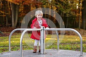 Laughing small girl playing in the park