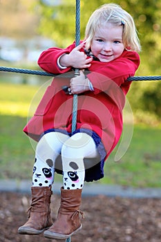 Laughing small girl playing in the park