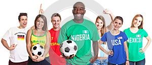 Laughing soccer fan from Nigeria with ball and other fans